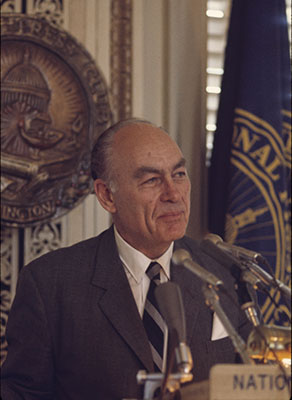 George Gallup gives a speech as he stands at a podium.