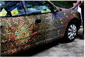 Photo of a 4 door sedan car, covered with bottle caps