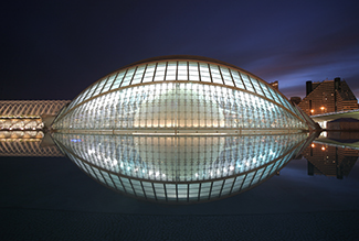 A picture of l’Hemisphèric, which is a giant glass structure that is in the shape of an ellipsoid.