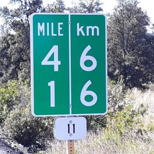 Hawaii: a road sign stating that 13 miles equals 21 kilometers